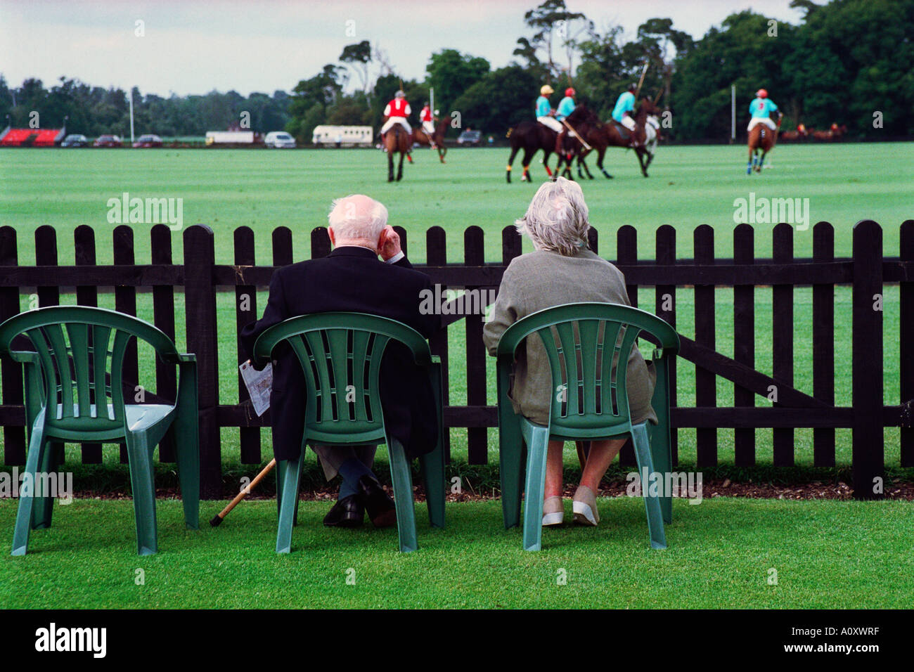 England, UK. Elderly couple watching polo at the Guards Polo Club, Queen s  Ground, Windsor Great Park, Surrey Stock Photo - Alamy