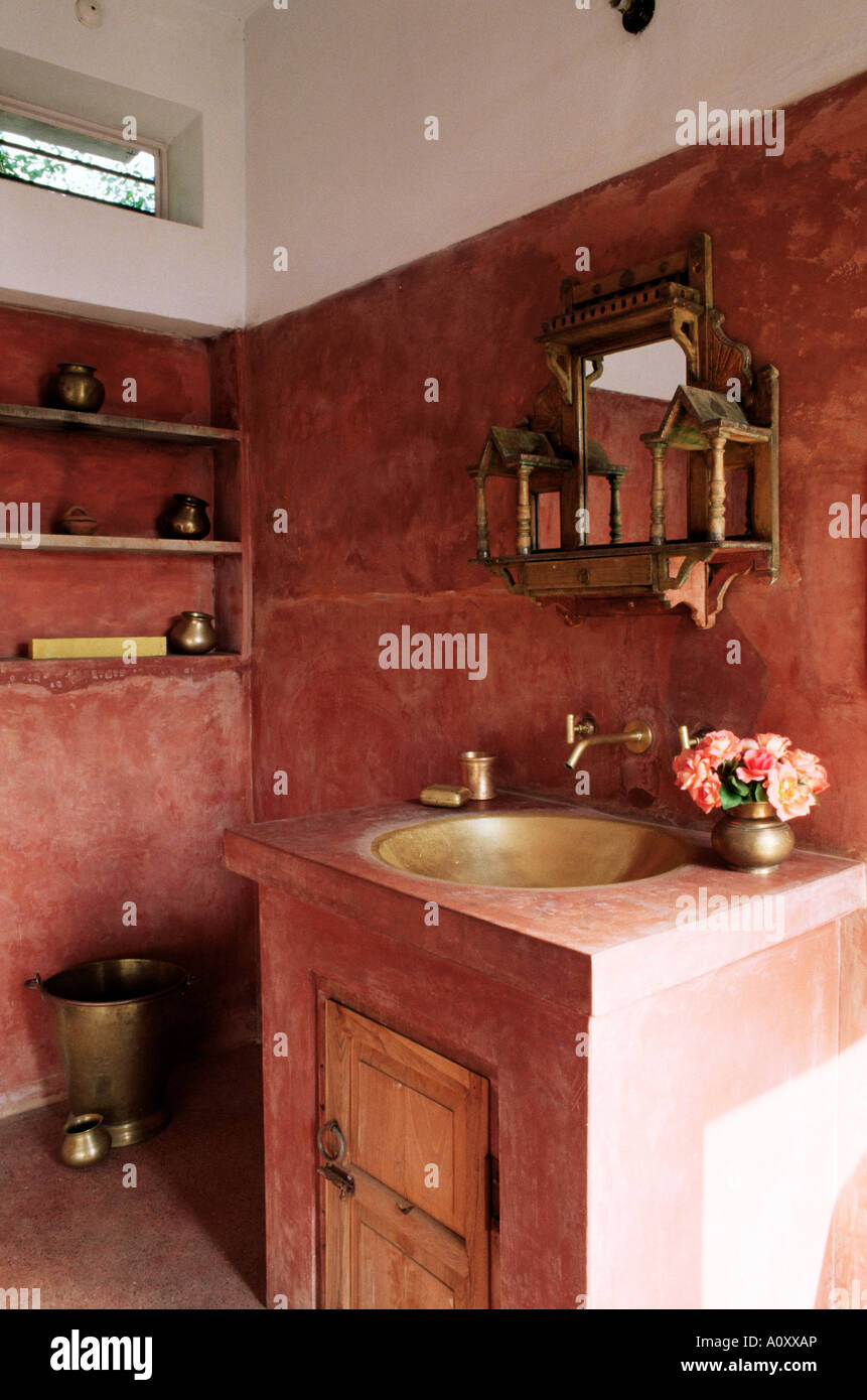 Pink finished plaster walls and hand beaten brass bathroom sink residential home Amber near Jaipur Rajasthan state India Asia Stock Photo