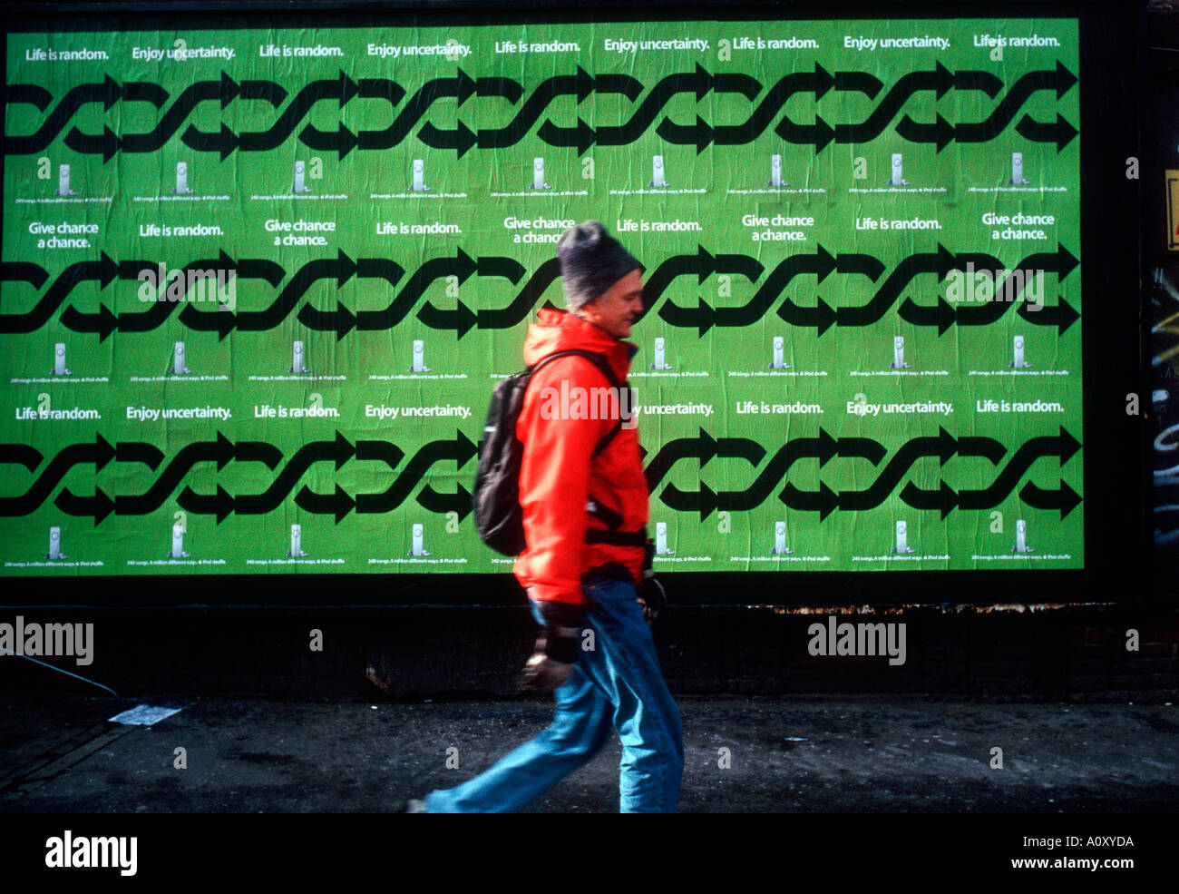 A passerby walks in front of an advertisement for the new Apple Computer iPod Shuffle Stock Photo
