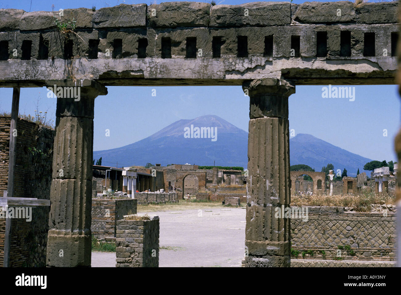 Versuvius Volcano seen from Pompeii buried in AD79 eruption Renovated stonework of a building on the edge of the Roman Forum Stock Photo