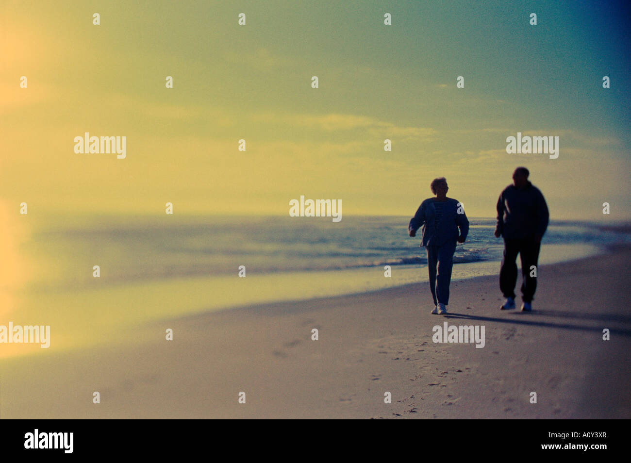 Senior couple walking on the beach Stock Photo - Alamy