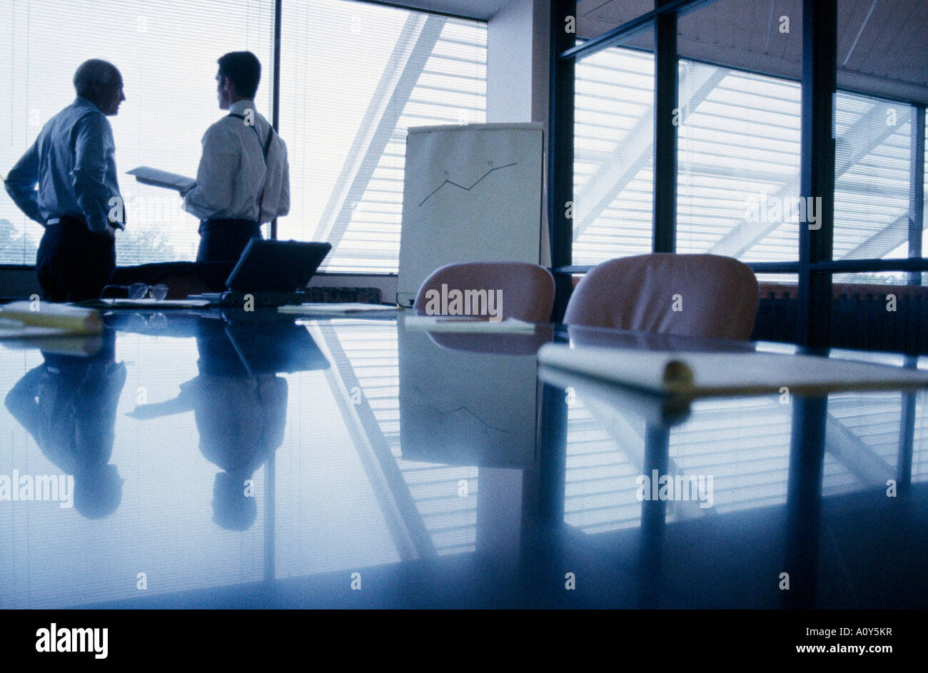 Two businessmen standing in an office Stock Photo - Alamy