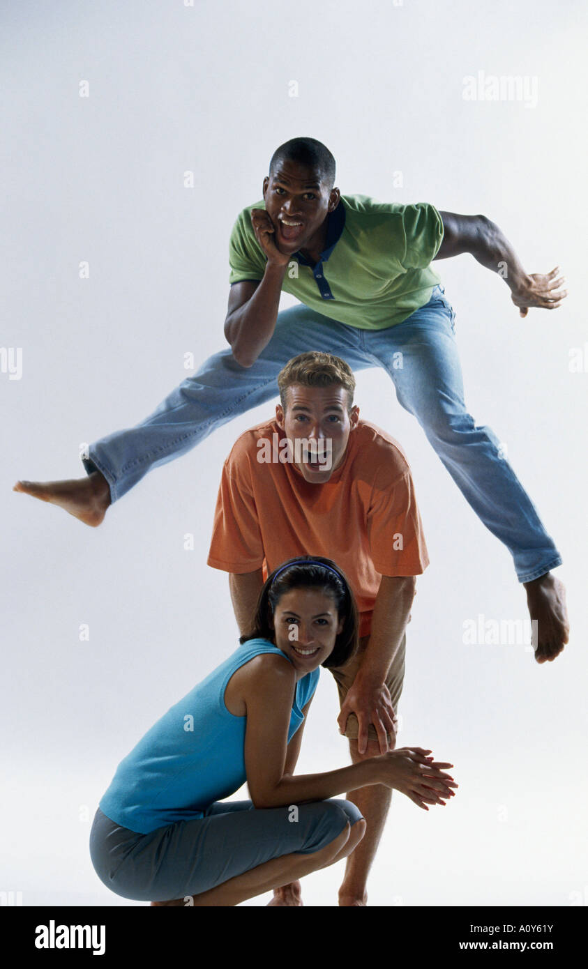 Portrait of two young men and a young woman posing Stock Photo - Alamy