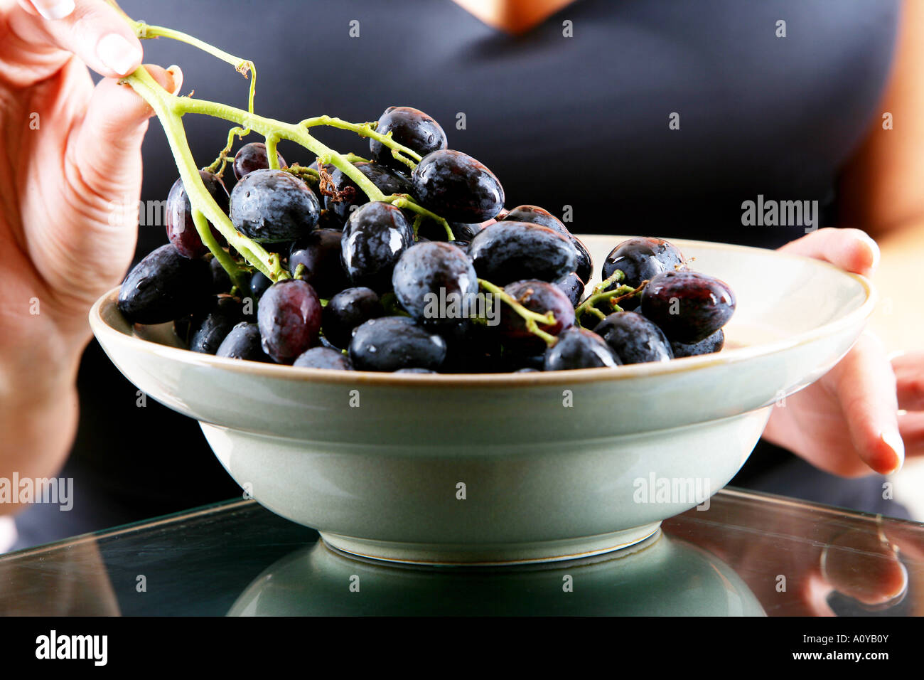 Young Woman Eating Red Grapes Model Released Stock Photo Alamy