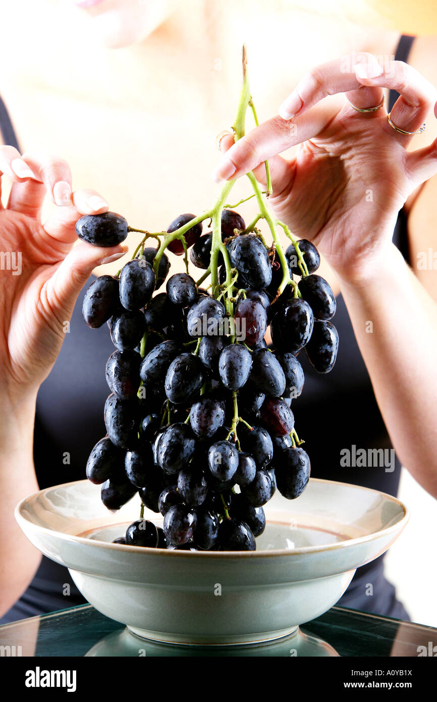 Young Woman Eating Red Grapes Model Released Stock Photo Alamy