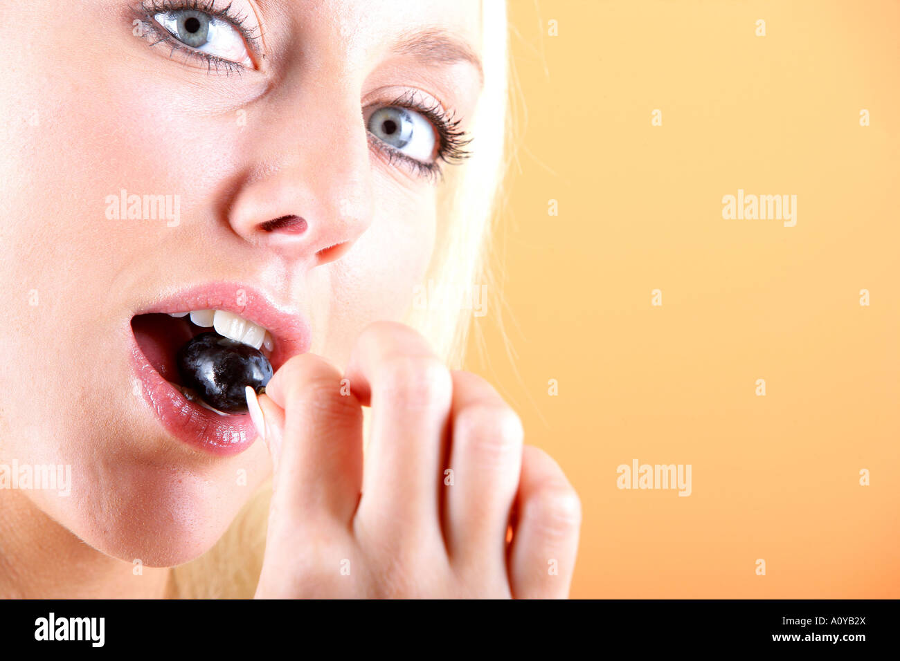 Young Woman Eating Red Grapes Model Released Stock Photo Alamy