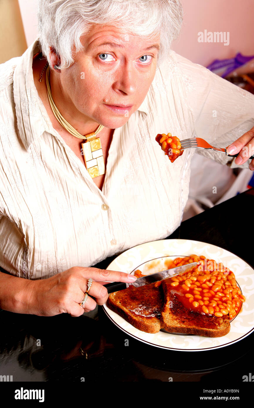 Mature Woman Eating Baked Beans on Wholemeal Toast Model Released Stock Photo Alamy