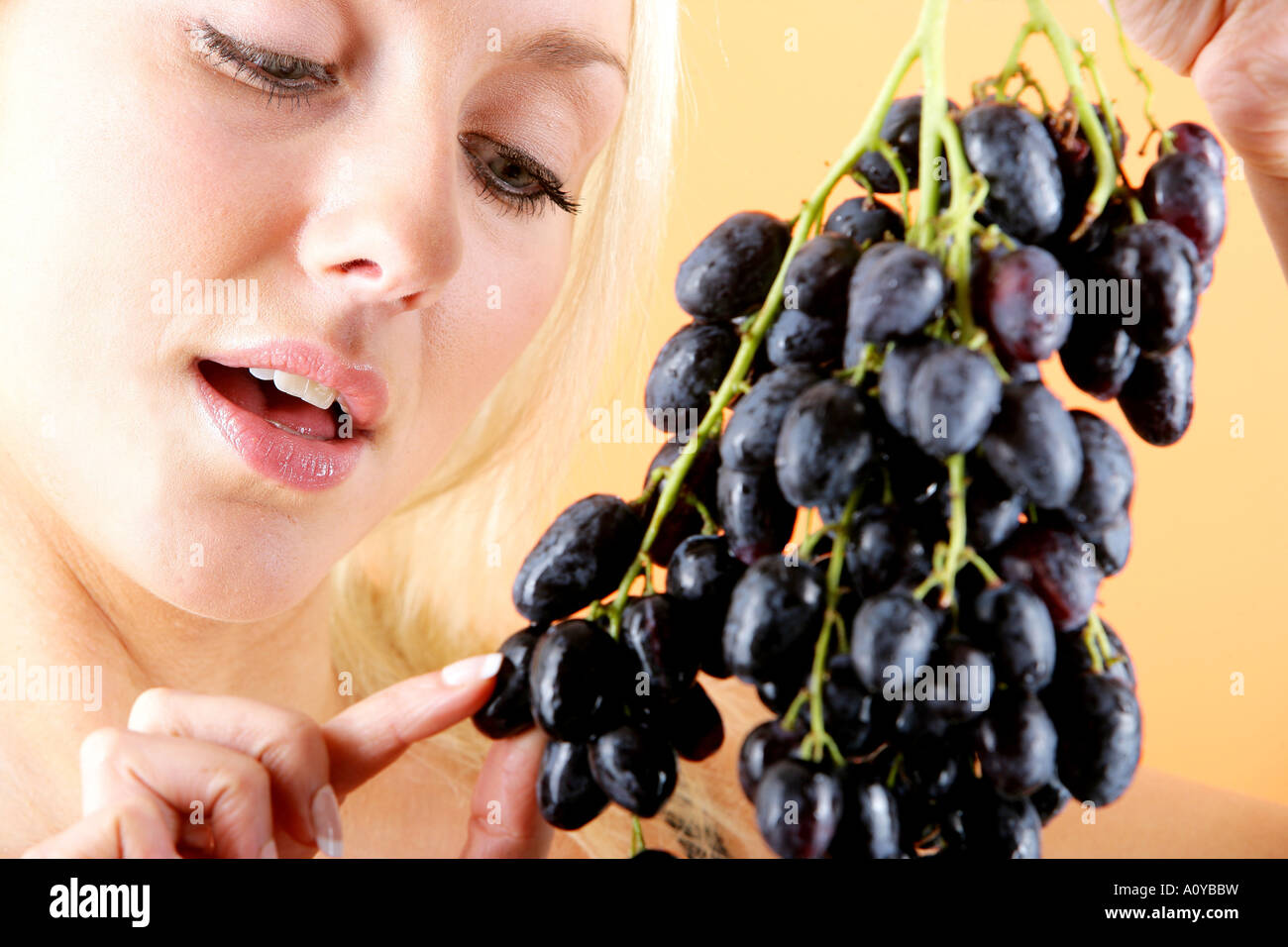 Young Woman Eating Red Grapes Model Released Stock Photo Alamy