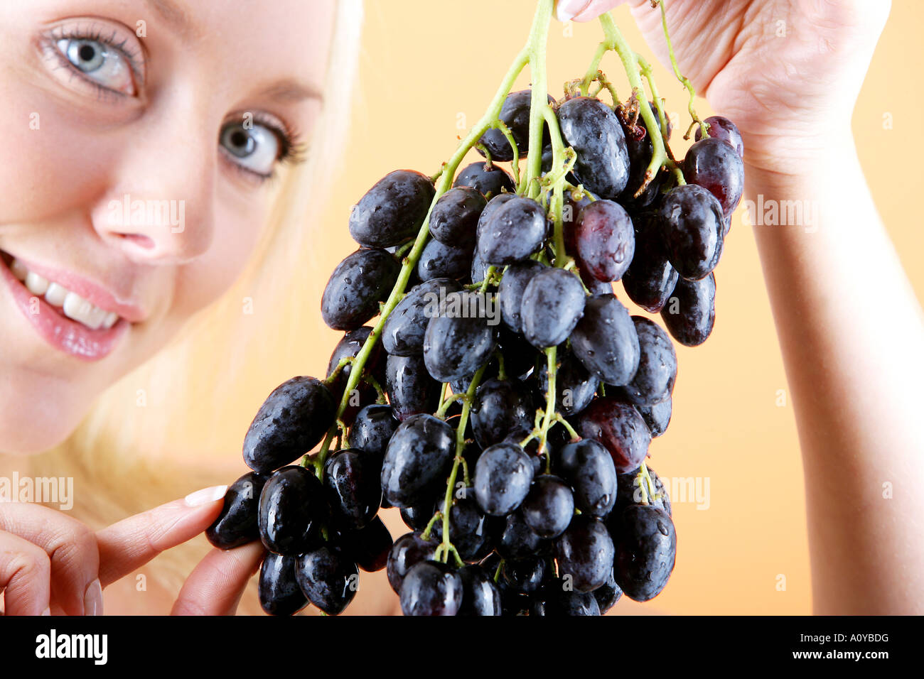 Young Woman Eating Red Grapes Model Released Stock Photo Alamy