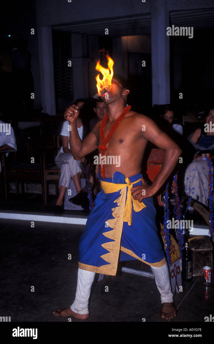 Sri Lankan man performs a traditional dance and fire eating routine Stock Photo