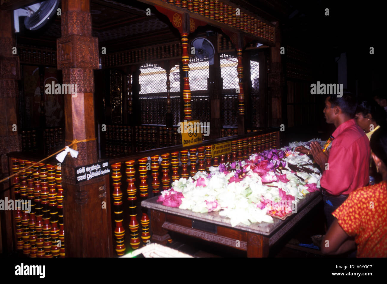 People praying at the Temple of the Tooth at Kandy in Sri Lanka that was Ceylon Stock Photo