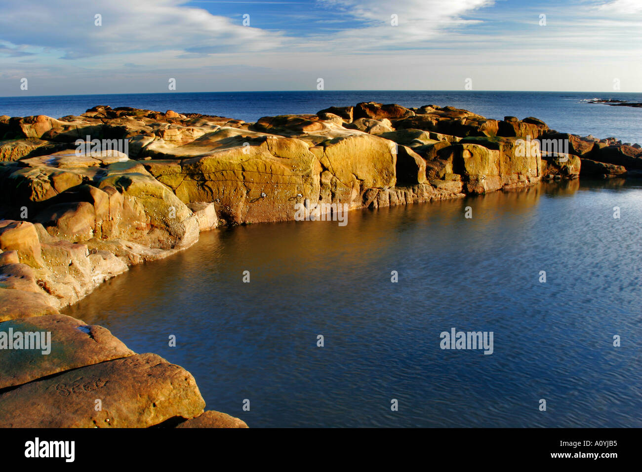 England Tyne and wear Cullercoats A swimming and bathing pool cut into the rocky coastline of the North Sea Stock Photo