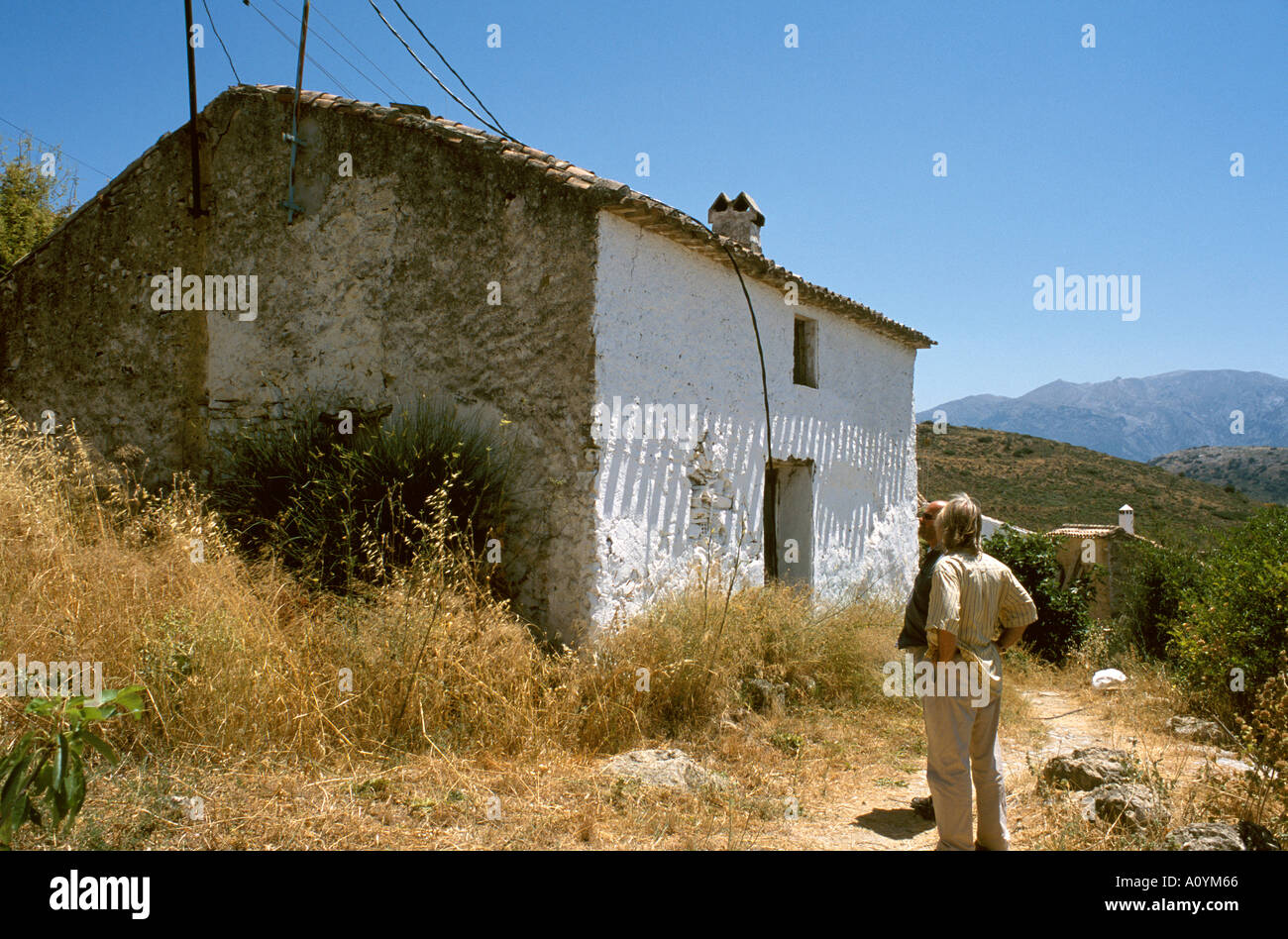 Prospective purchaser looking at derelict cottage in Spain waiting for restoration Stock Photo