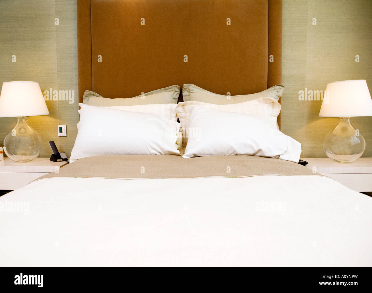 Made bed with matching lamps Stock Photo Alamy