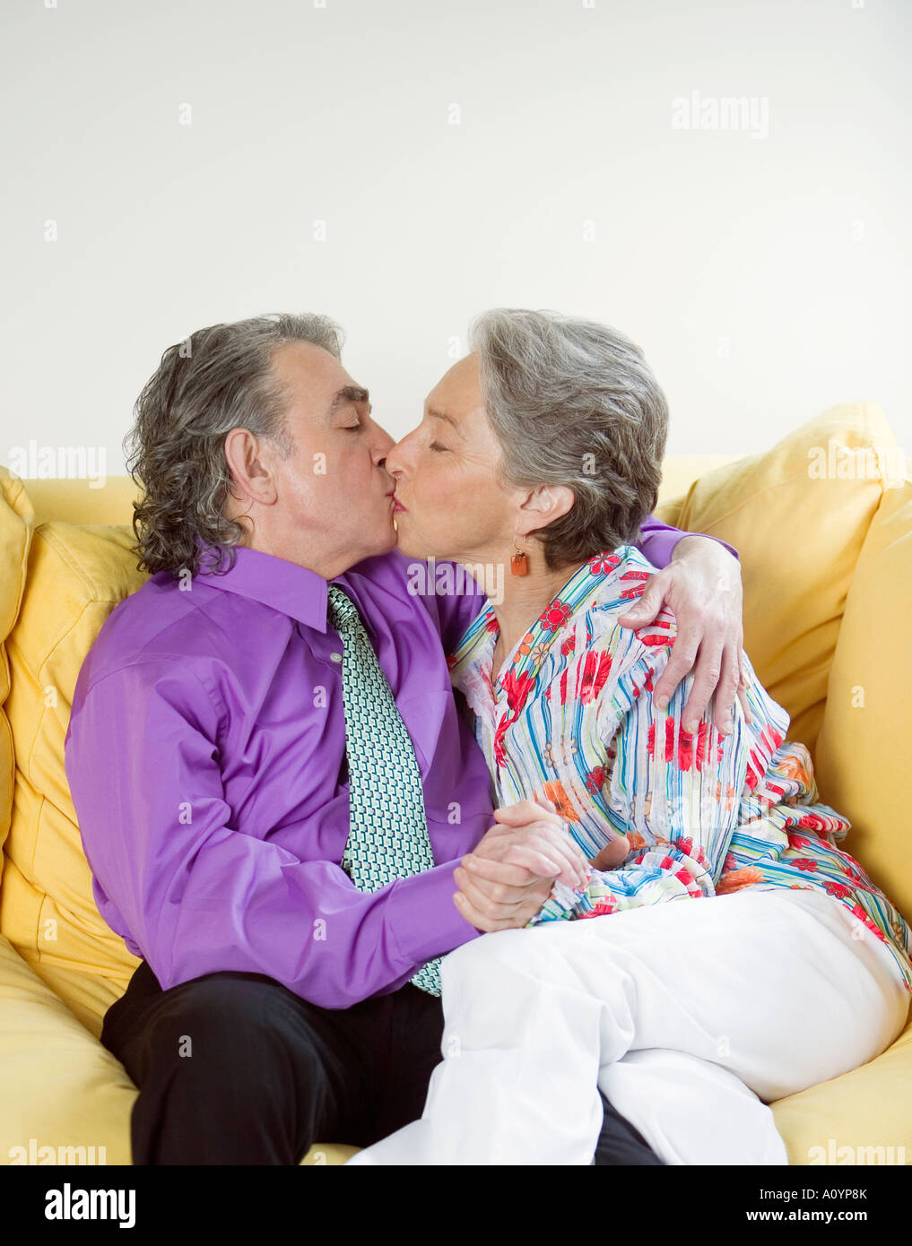 Senior couple kissing on sofa Stock Photo - Alamy