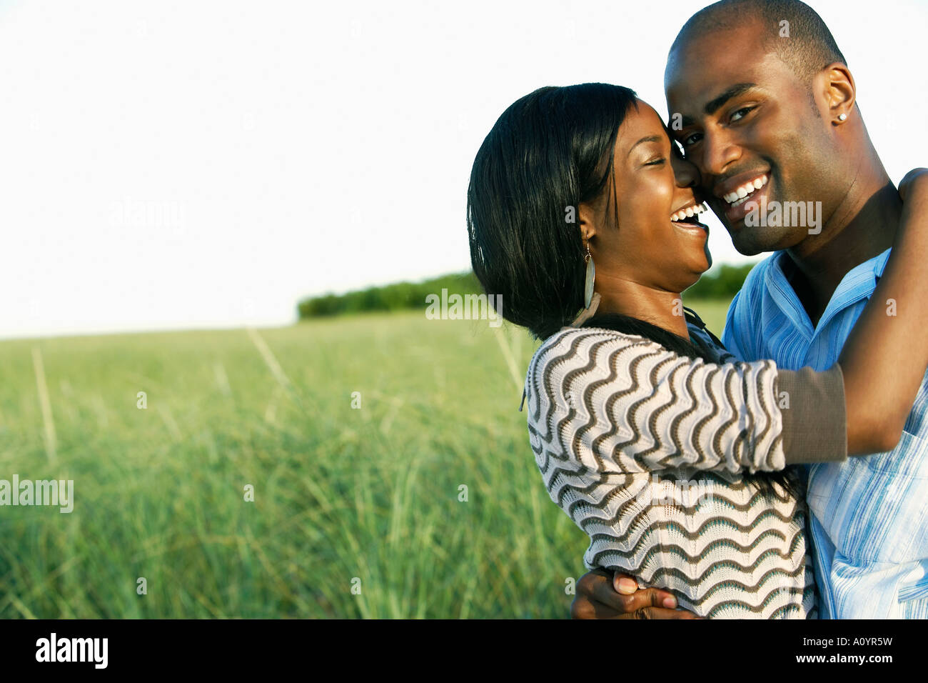 Young African couple smiling Stock Photo - Alamy