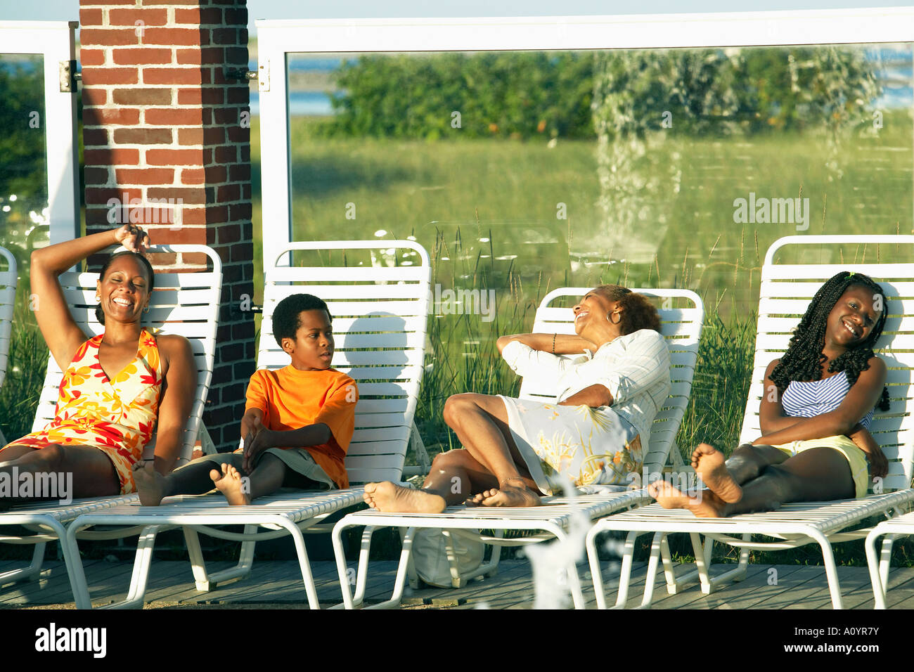 Young African couples relaxing in lawn chairs Stock Photo - Alamy
