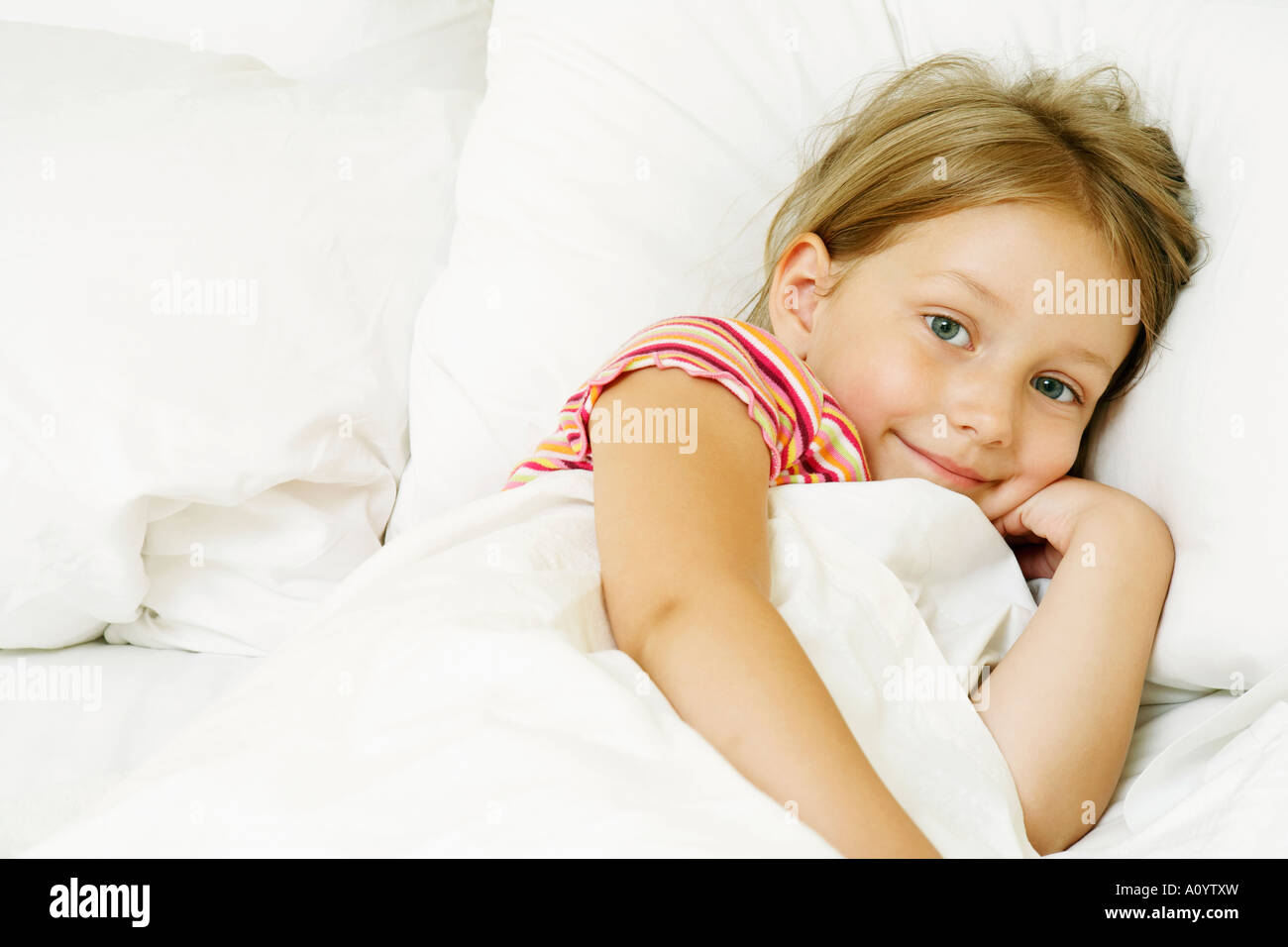 Young girl tucked in bed Stock Photo Alamy