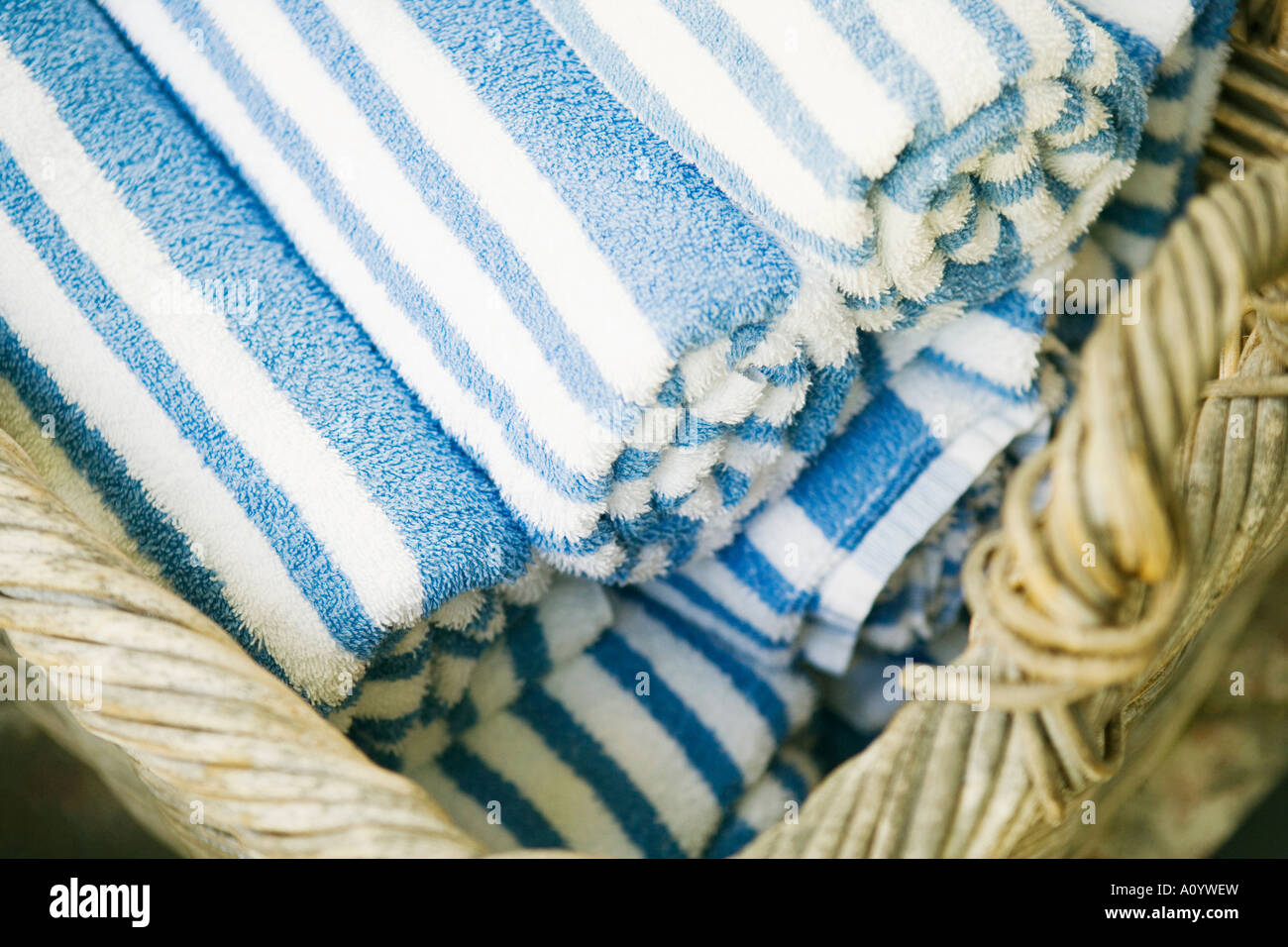 Towels rolled up in wicker basket Stock Photo Alamy