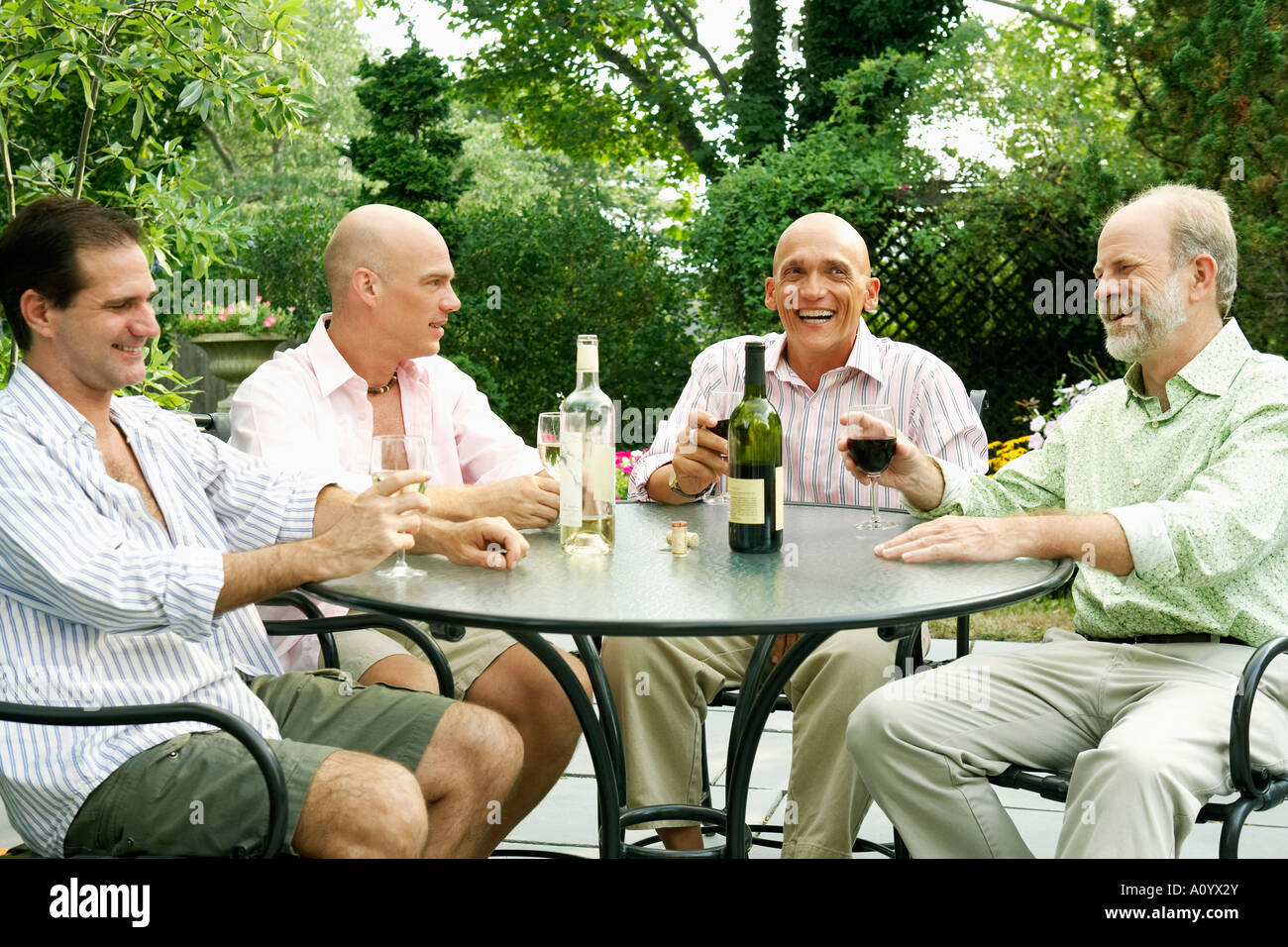 Two gay couples drinking wine together Stock Photo