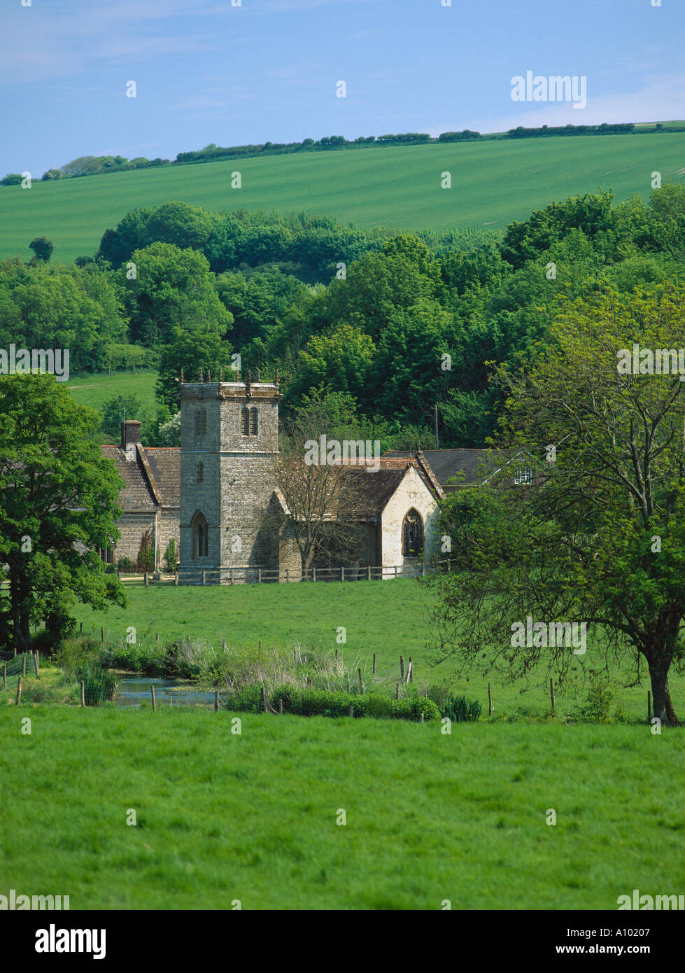 English country church hidden in a spring green valley Stock Photo - Alamy