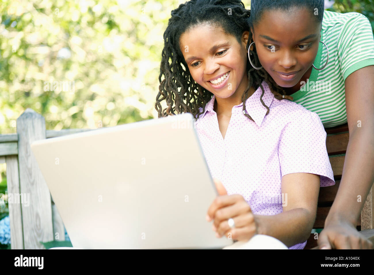 Young African women using a laptop outdoors Stock Photo - Alamy