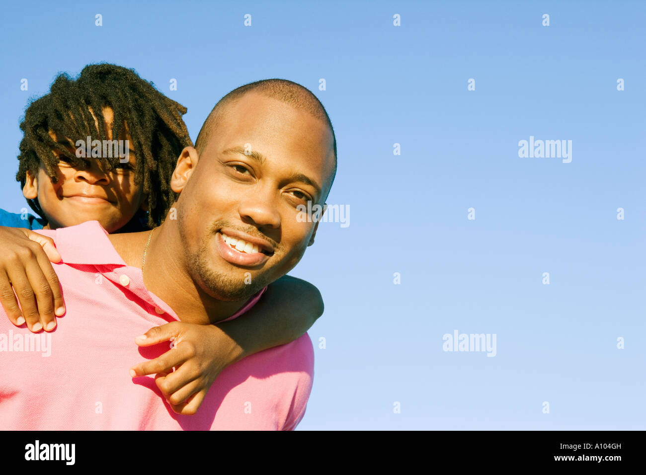 African father carrying his daughter on his shoulders Stock Photo - Alamy