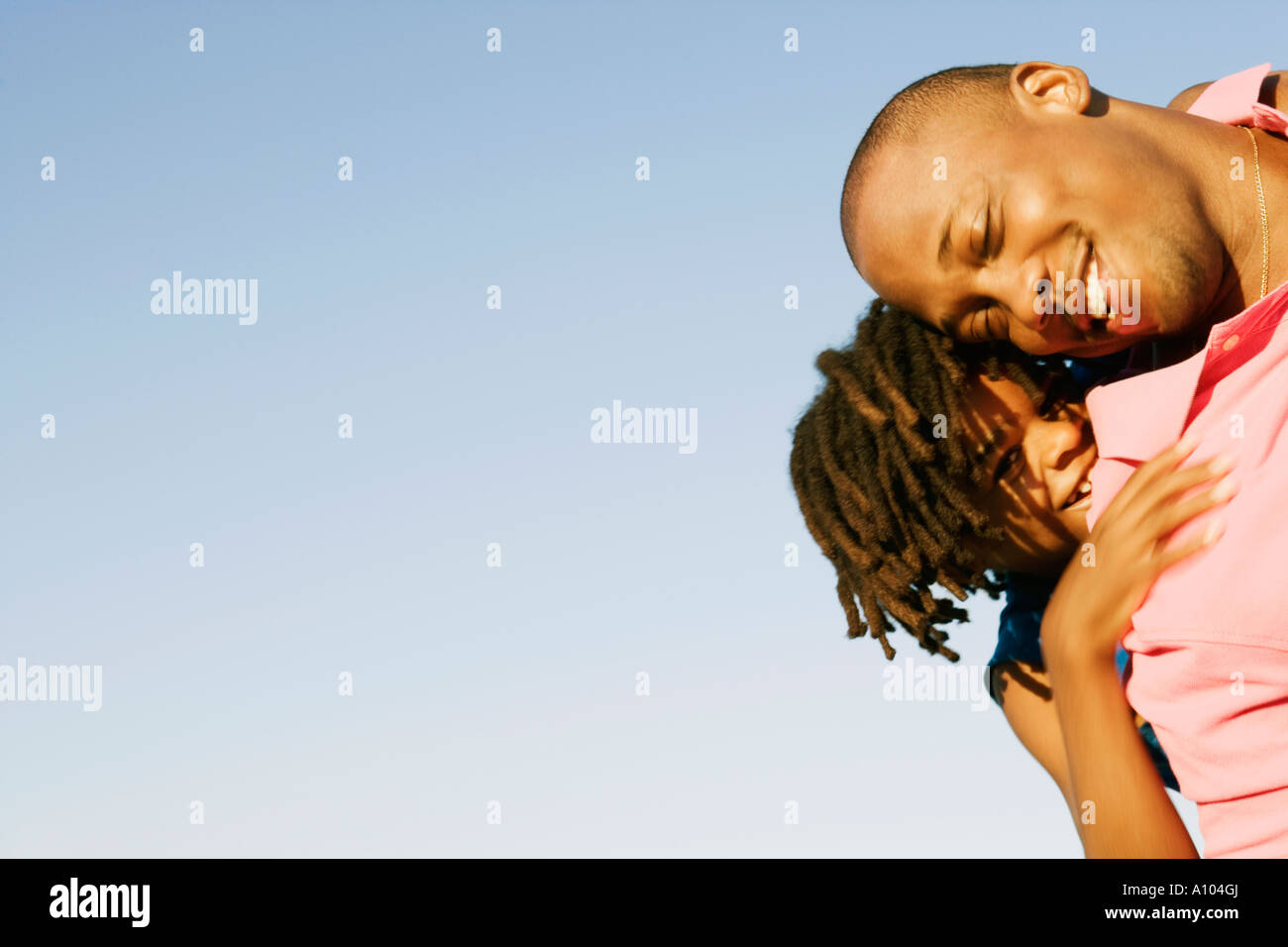 African father carrying his daughter on his shoulders Stock Photo - Alamy
