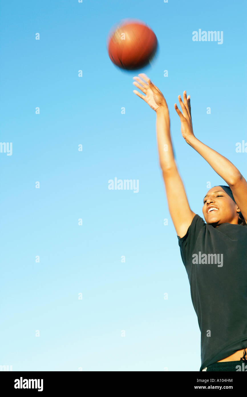 Teenage girl throwing basketball hires stock photography and images
