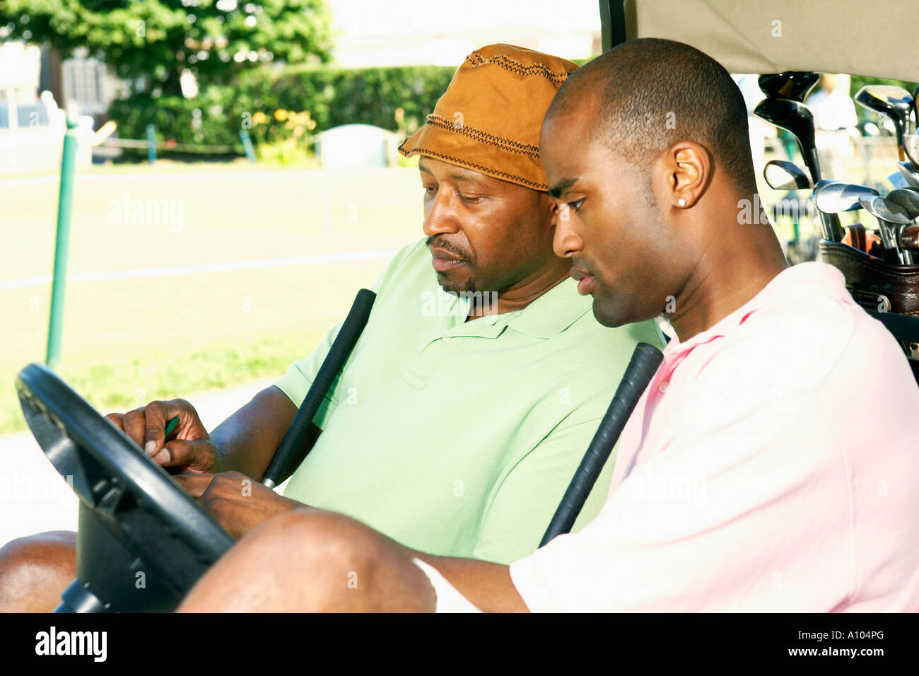 African men keeping score of their golf game Stock Photo