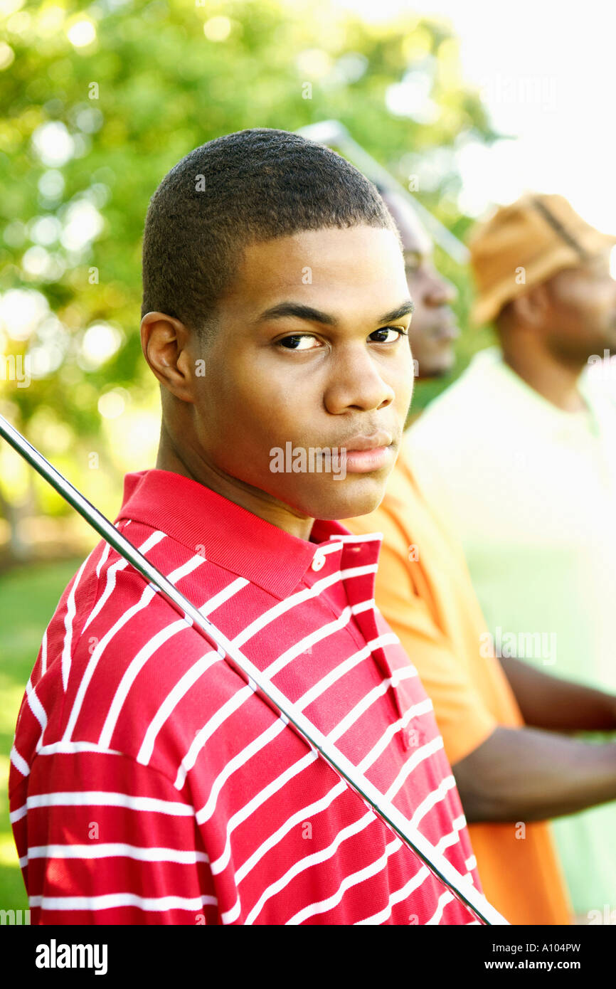 Teenage African boy playing golf Stock Photo Alamy