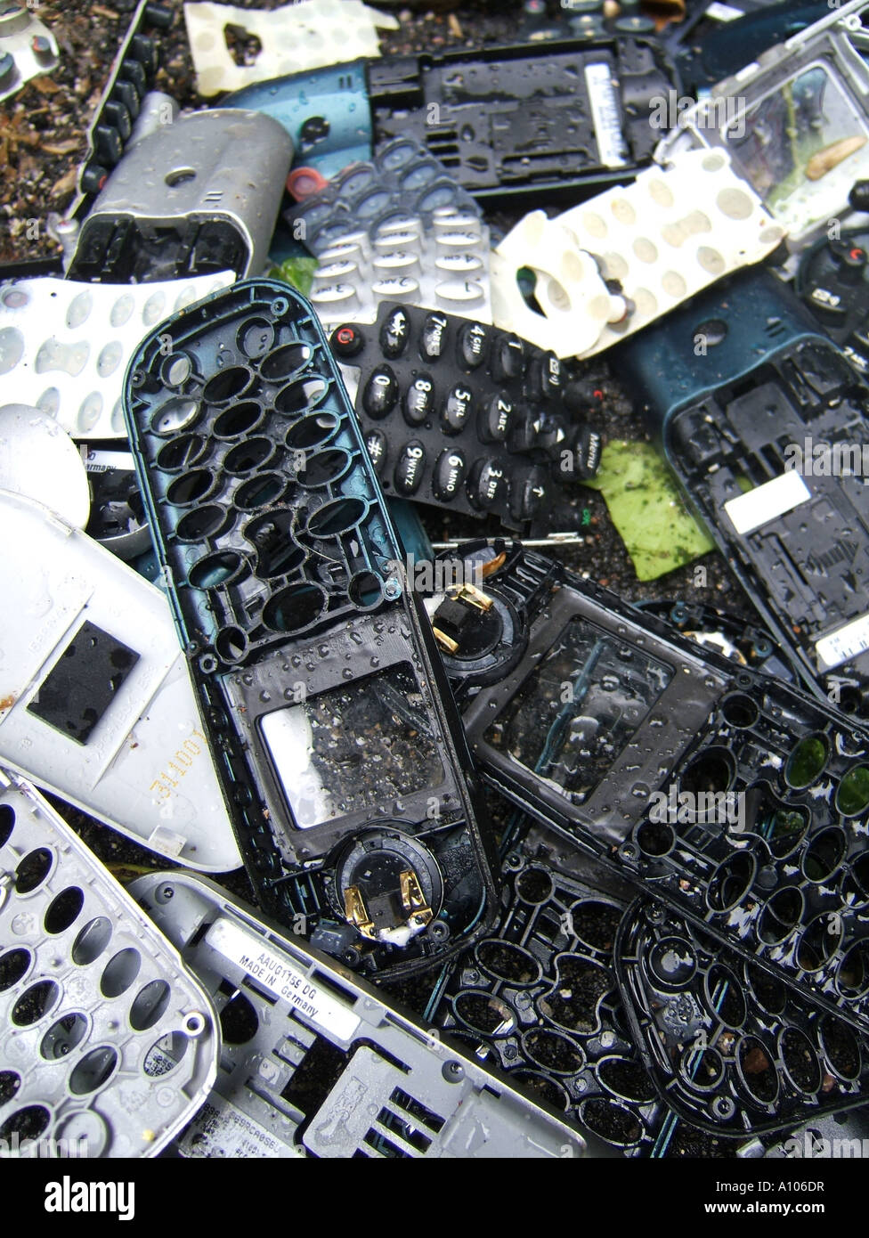 pile of old mobile phone covers dumped on road Stock Photo