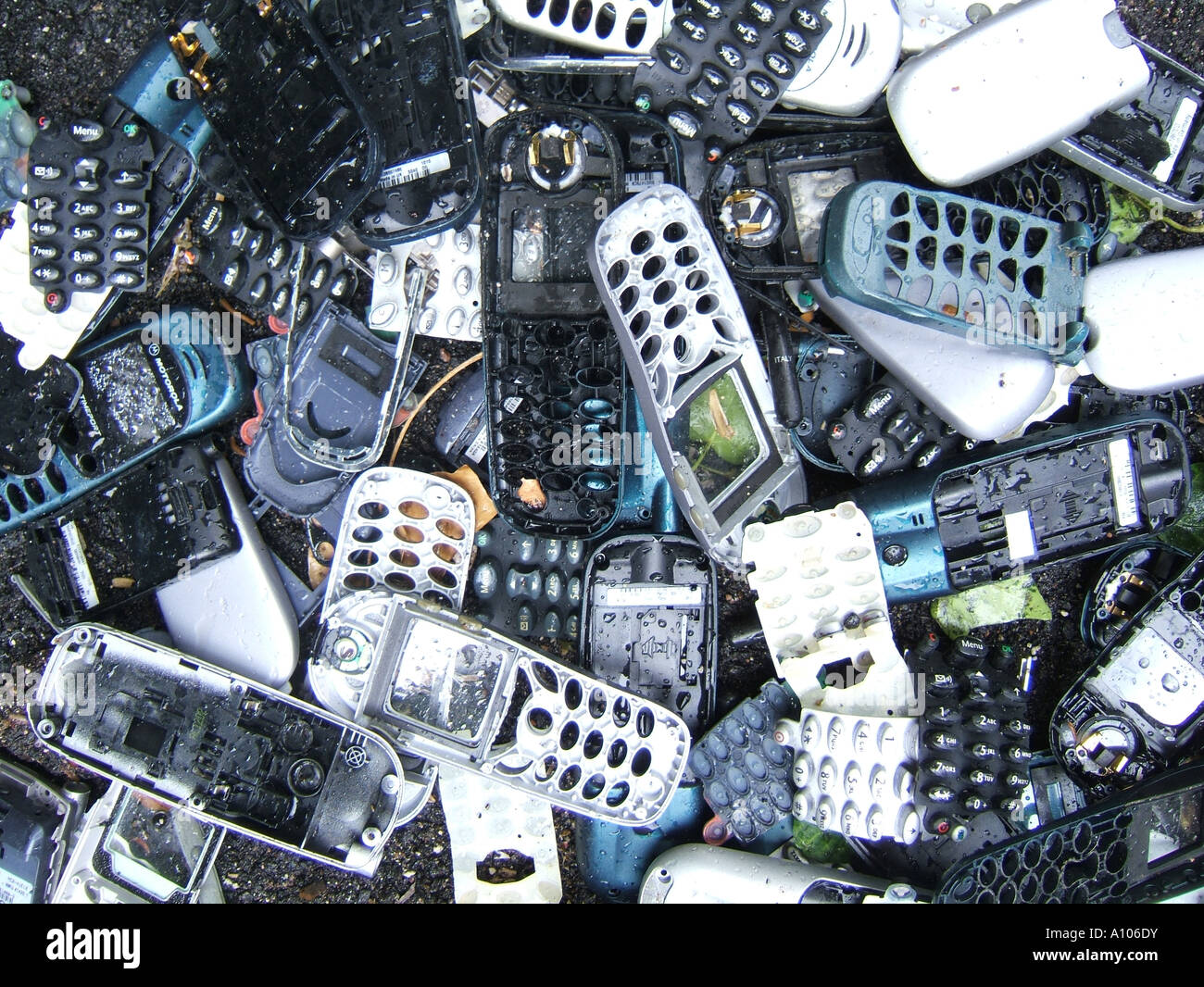 pile of old mobile phone covers dumped on road Stock Photo