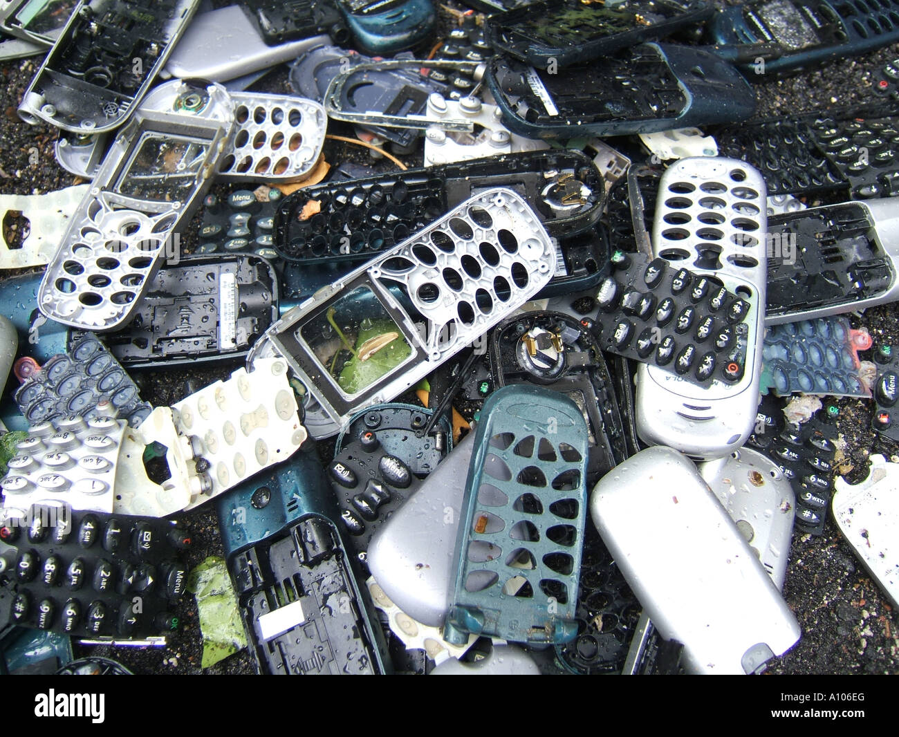 pile of old mobile phone covers dumped on road Stock Photo