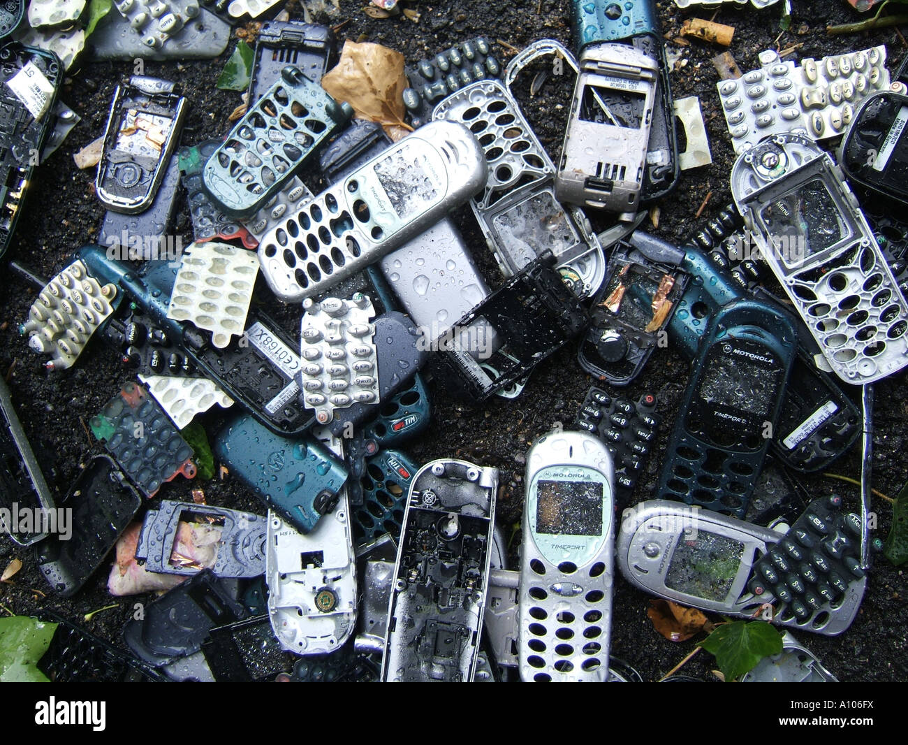 pile of old mobile phone covers dumped on road Stock Photo