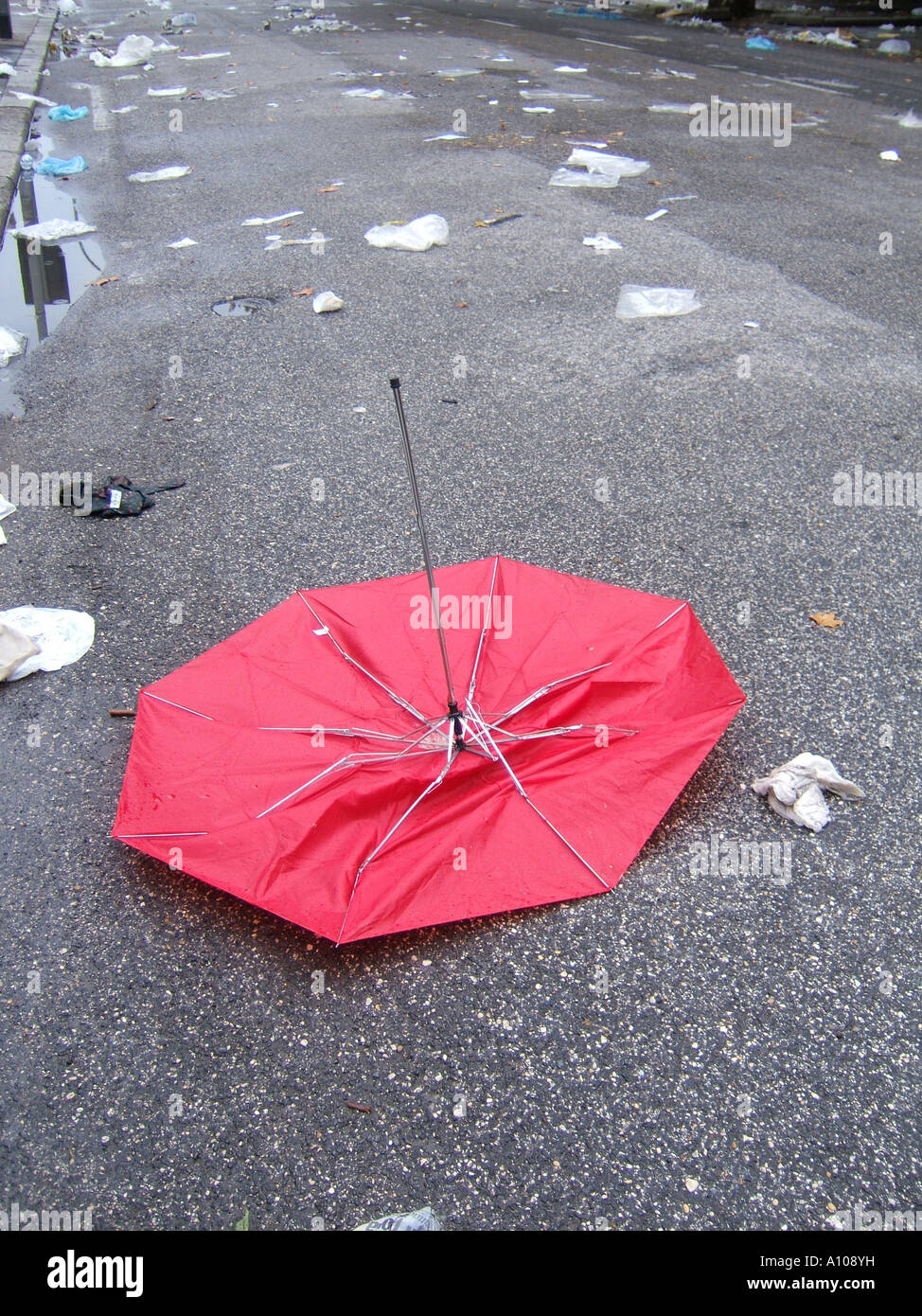 broken red umbrella on dirty road Stock Photo Alamy