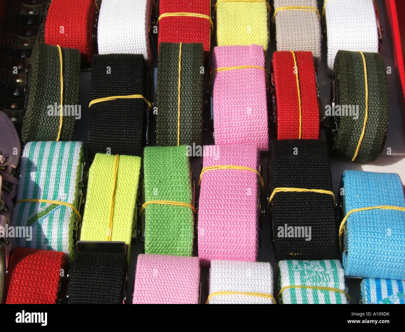 colourful canvas belts on display Stock Photo - Alamy