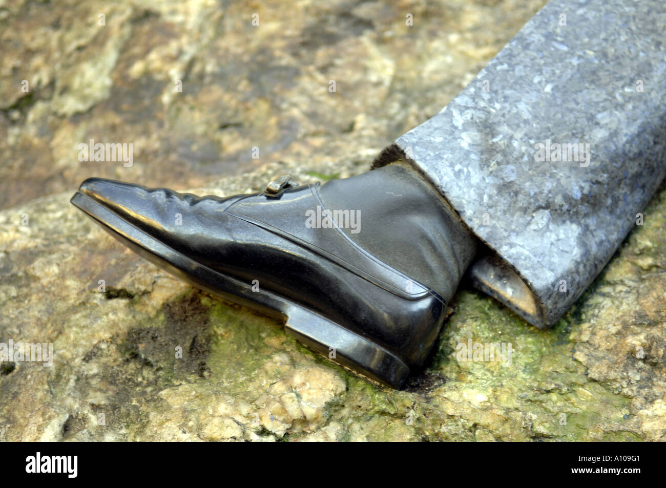 detail trouser leg right foot shoe black rock oscar wilde Stock Photo