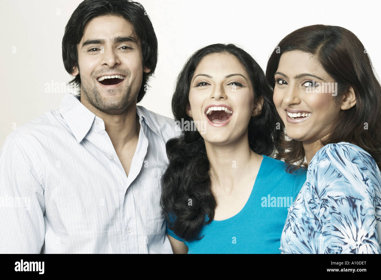 Portrait of two young women and a young man laughing Stock Photo - Alamy