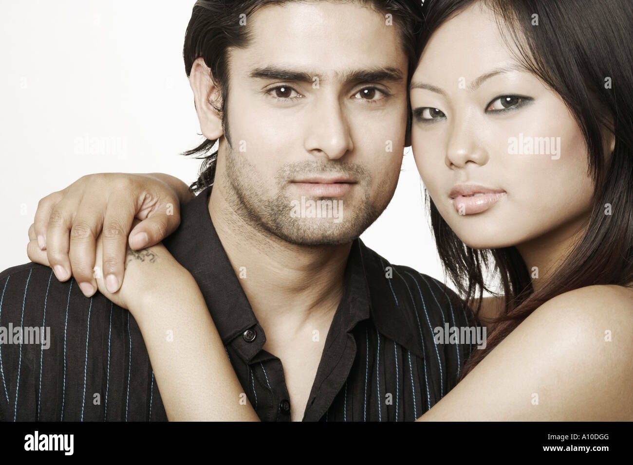 Portrait of a young woman embracing a young man Stock Photo - Alamy