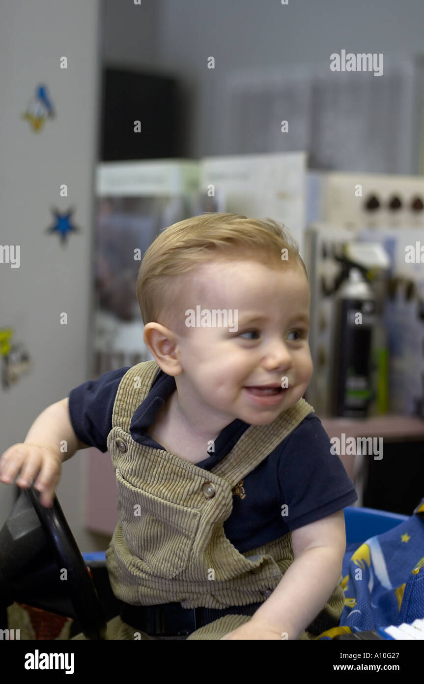 One year old boy sits in barber stool for first haircut Model ...