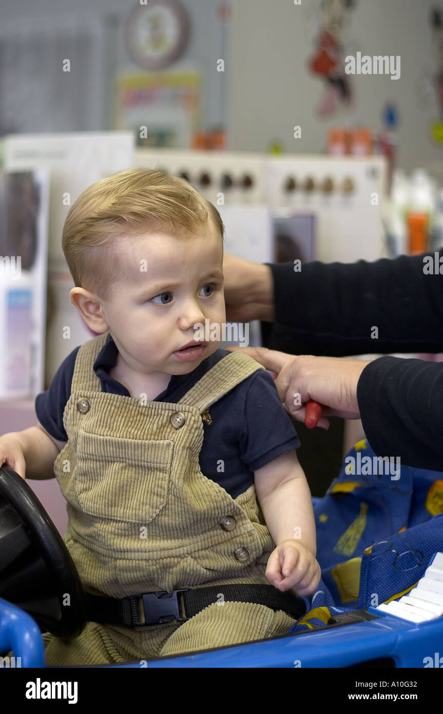 One Year Old Boy Sits In Barber Stool For First Haircut Model