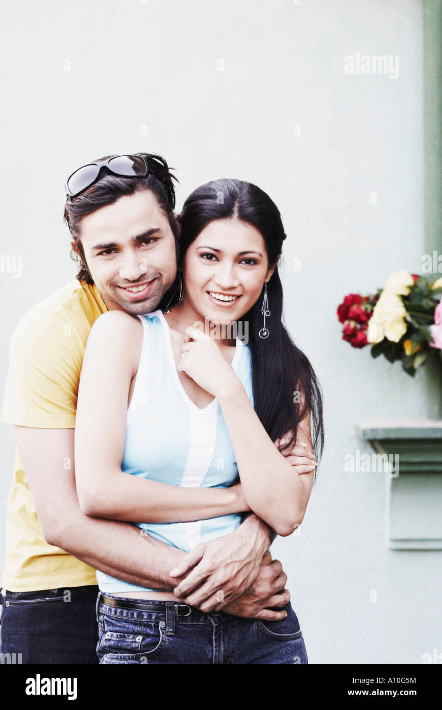 Portrait of a young man embracing a young woman Stock Photo - Alamy