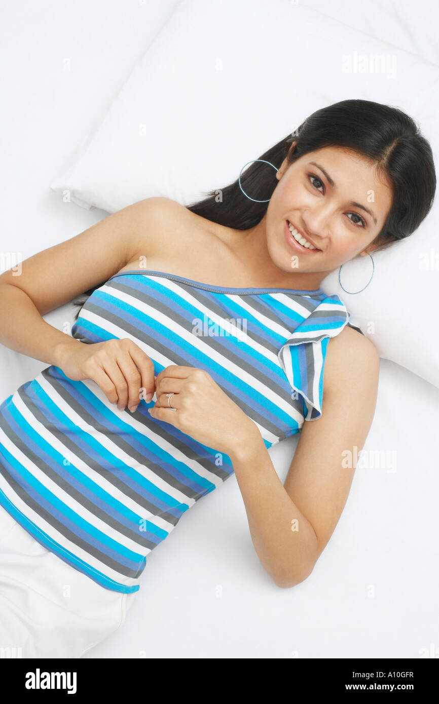 Portrait of a young woman lying on her back and smiling Stock Photo - Alamy