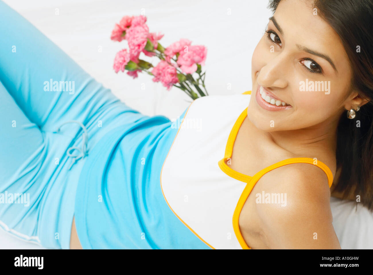 Portrait of a young woman holding a bunch of flowers and smiling Stock ...