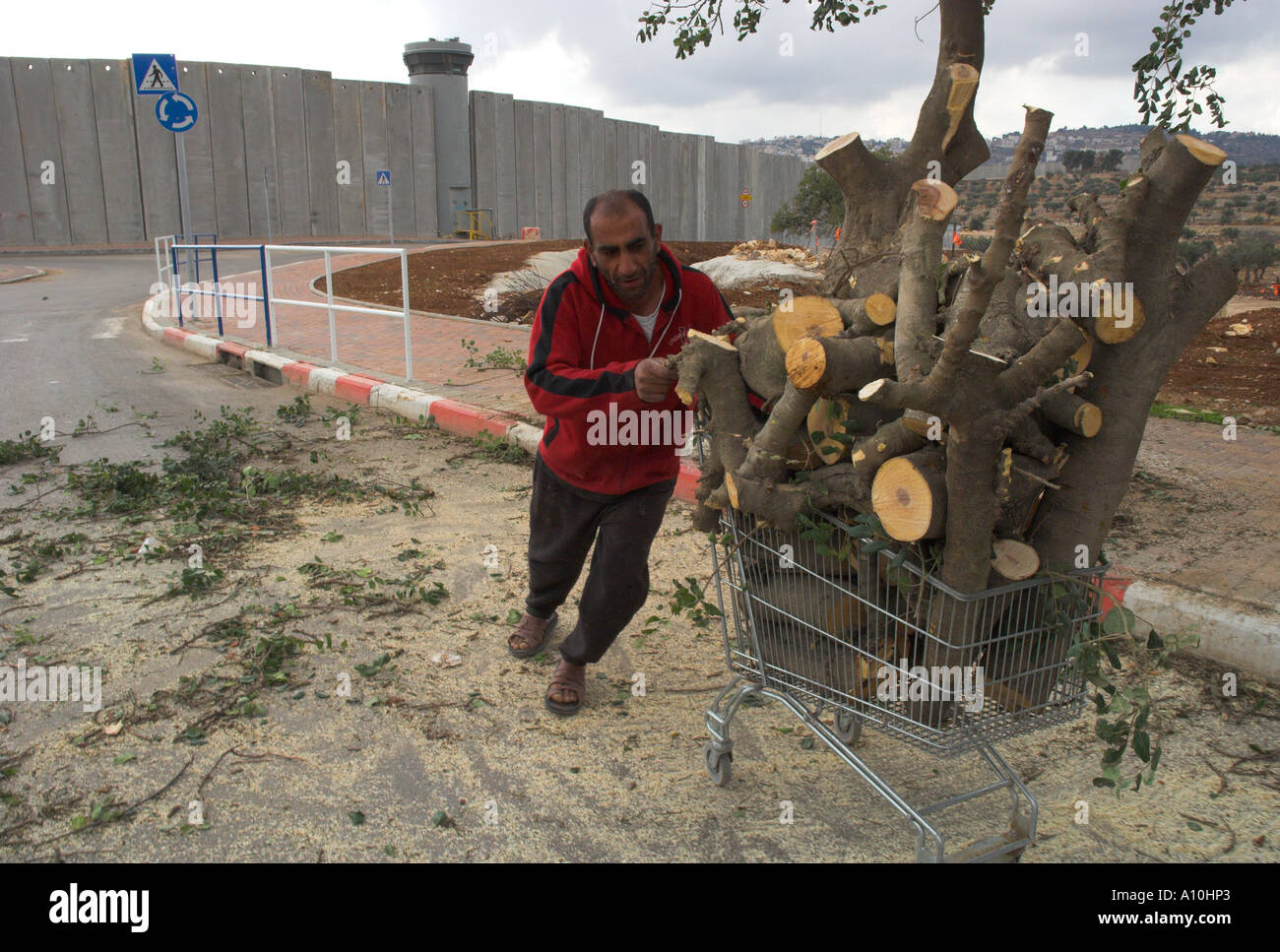 Isreal Jerusalem The Fence between Israel and the Palestinian Authority at the entrance to Bethlehem view with Palestinian man t Stock Photo