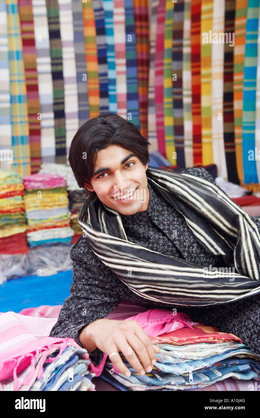 Portrait of a young man lying in a clothing store Stock Photo - Alamy