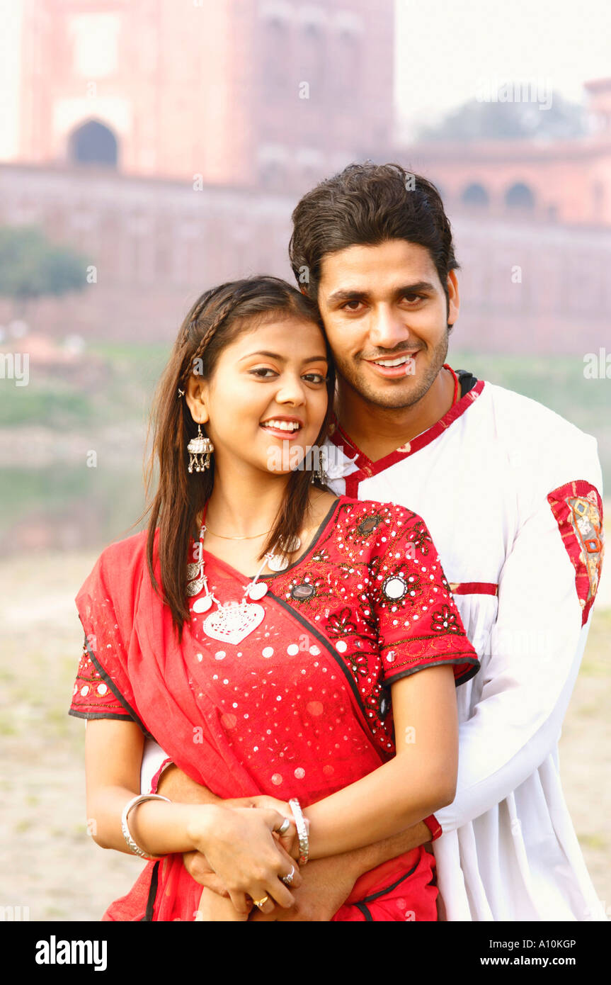 Portrait of a young man embracing a young woman Stock Photo - Alamy
