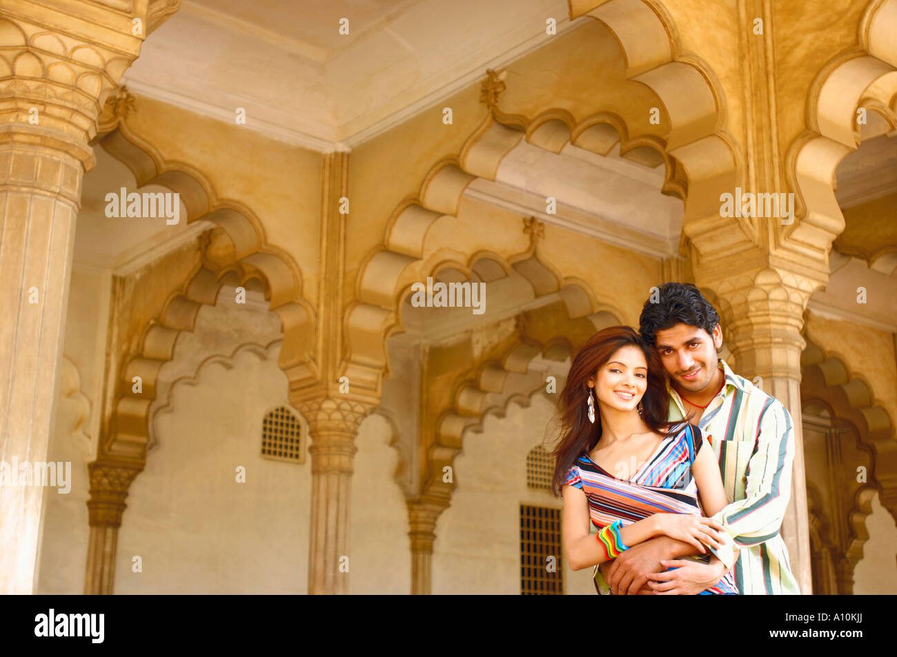 Portrait of a young man embracing a young woman Stock Photo - Alamy