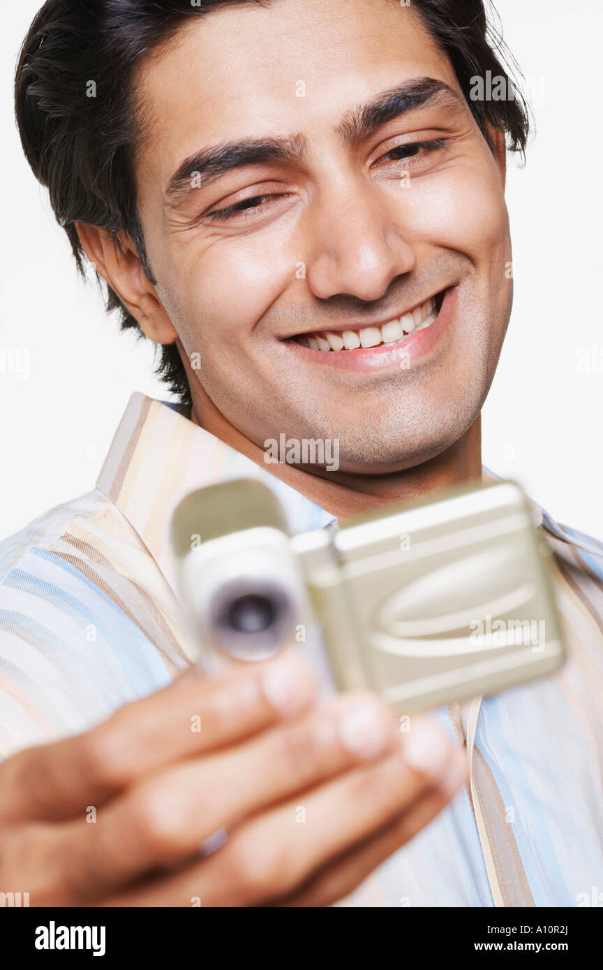 Close-up of a young man using a video camera Stock Photo - Alamy